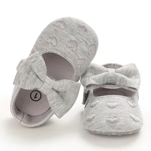 Detailansicht grauer Baby-Mary-Janes mit Herzstickerei und Schleife