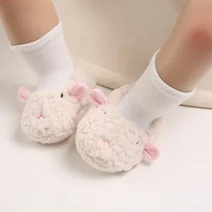 Close-up of adorable cream lamb-shaped fuzzy warm baby slippers with soft soles