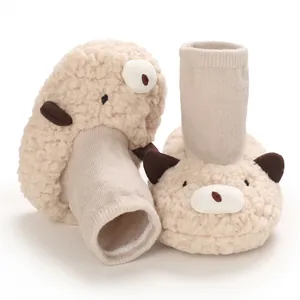 Macro detail showing soft sherpa texture and cartoon animal faces on warm baby socks