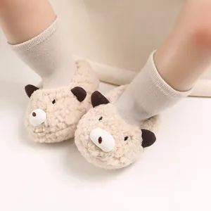 Detail view of soft warm bear-shaped baby slippers for 0-1 year old infants.
