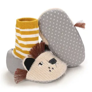 Detail showing the anti-slip sole and cute plush lion face of baby warm booties