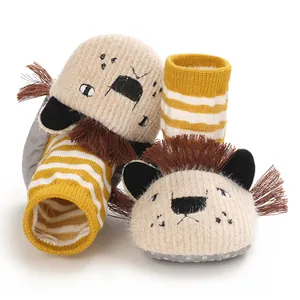Close-up view of cute cartoon lion design on infant soft-sole warm knitted slippers