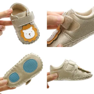 Detail view of gold lion infant walking shoe showing soft sole and Velcro strap