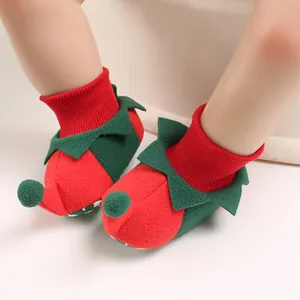 Detail view of festive red and green elf baby shoes with soft knit cuffs