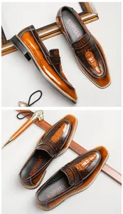 Close-up of premium brown leather loafers featuring embossed alligator head patterns.