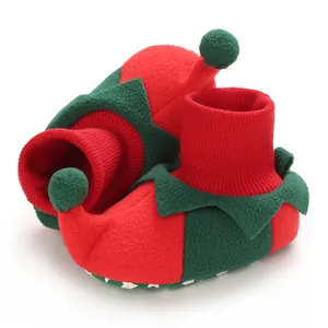 Detail of festive red and green baby elf booties with soft fleece and knit cuffs