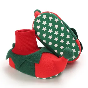 Detail of baby Christmas elf booties with warm fleece and star pattern non-slip sole