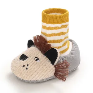 Adorable cartoon lion baby booties with soft soles and yellow striped knit ankle part