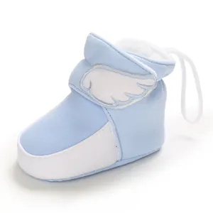 Detail eines warmen blauen Baby-Schneestiefels mit Flügelstickerei und weichem Fleecefutter.