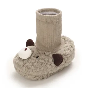 Detailed view of soft plush baby winter boots featuring a cute cartoon bear design for warmth