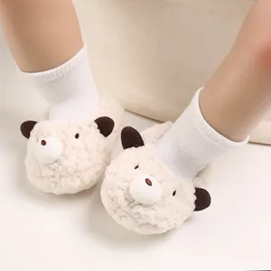 Detail of cream-colored fleece baby winter boots featuring a cute bear face design and soft socks