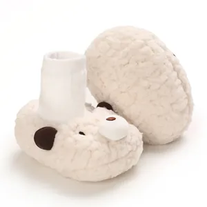 Detailed view of cute cartoon bear baby winter boots made of warm white plush material