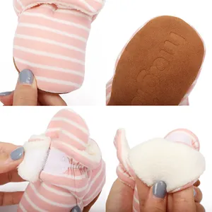 Detail view of pink striped baby winter booties showing fleece lining and anti-slip sole