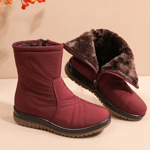 Waterproof maroon women's snow boots with thick faux fur lining and non-slip sole