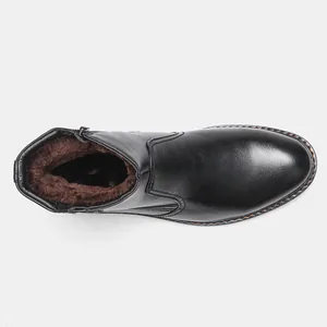 Vista superior de botas de invierno negras para hombre con forro polar marrón cálido