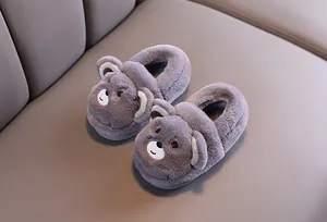 Gros plan détaillé sur d'adorables chaussons en peluche gris pour bébé en forme d'ours polaire