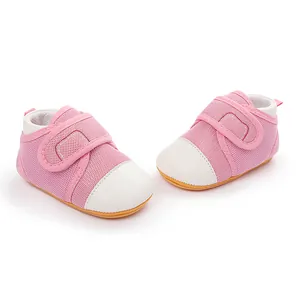 Close-up of pink mesh baby walker shoes with white toe cap and rubber sole.
