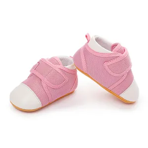 Detailed view of pink mesh baby shoes featuring white toe caps and anti-slip rubber soles.