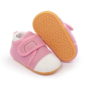 Detailed view of pink baby walking shoes with white toe cap and anti-slip rubber sole