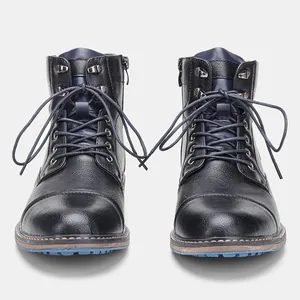 Vue de face de bottes de travail pour hommes avec fermeture éclair et semelle bleue.