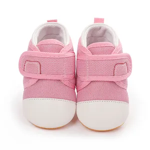 Close-up of pink mesh baby walking shoes with white toe caps and hook-and-loop straps.