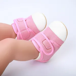 Close-up of pink mesh baby walking shoes with anti-slip rubber soles and white toe caps