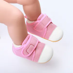 Close-up of pink mesh baby walking shoes featuring a white rubber toe and Velcro
