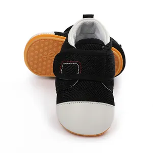 Close-up detail shot of breathable black baby walker shoes with non-slip rubber soles.