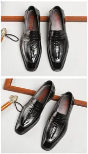 Detailed view of black patent leather loafers with square toe and embossed totem