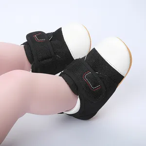 Detail of baby walking shoes featuring breathable black mesh upper and non-slip rubber sole