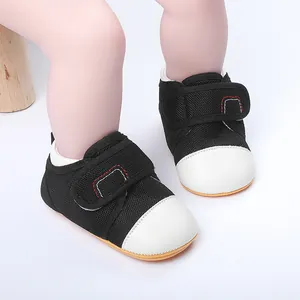 Close-up of baby walker shoes with breathable black mesh and white toe cap detail