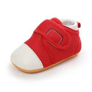 Detail view of red mesh baby walking shoe with breathable fabric and white toe cap