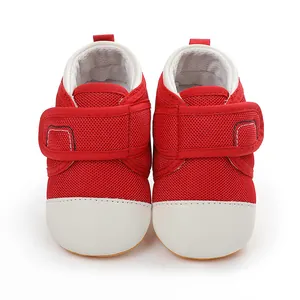 Front view detail of red mesh baby toddler shoes with white toe cap and velcro strap