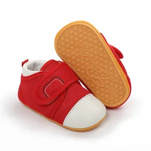 Detail of red baby walker shoes showing anti-slip rubber sole and soft mesh