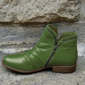 Side view of green retro leather ankle boot with pleated texture and side zipper detail.
