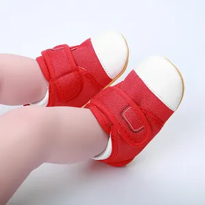 Close-up of red and white baby walker shoes with breathable mesh and secure Velcro straps