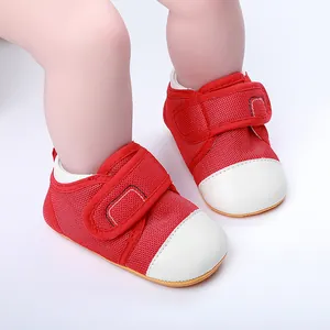 Detail view of red baby walking shoes with anti-slip rubber soles and velcro straps