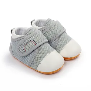 Detail view of grey mesh baby walking shoes with anti-slip rubber sole and Velcro strap.