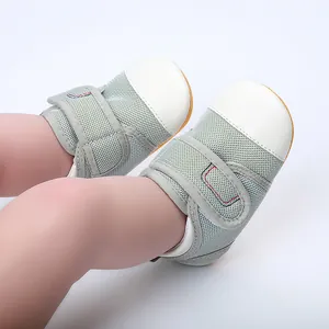 Detail of breathable grey mesh baby walking shoes with white leather toe caps