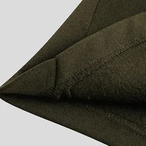Detailed view of the thickened fleece lining and knit fabric on olive green men's jacket