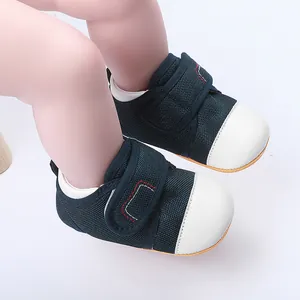 Close-up of navy mesh baby walking shoes with white rubber toes and Velcro straps