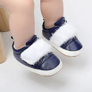 Close-up of navy blue baby winter pre-walker shoes with white faux fur trim detail