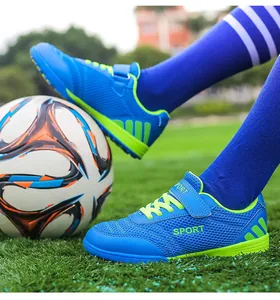 Breathable blue mesh children's soccer shoes with turf cleats and hook and loop strap.
