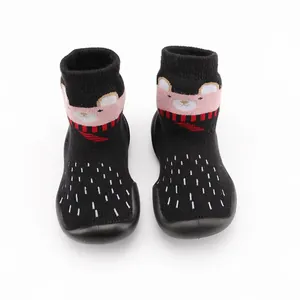 Detail view of thickened baby sock shoes with cute cartoon bear pattern and soft soles