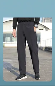 Full length view of men's black nylon outdoor casual sports pants on model in sunlight
