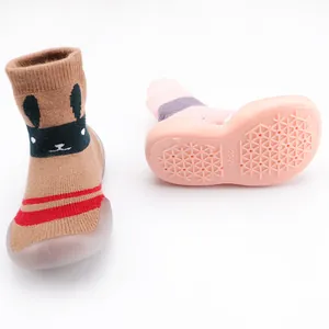 Close-up of non-slip rubber sole and rabbit design on thickened baby sock shoes.