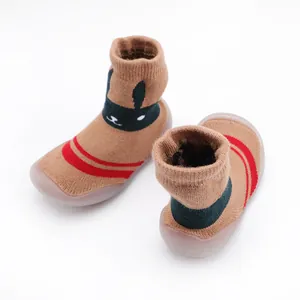 Detail view of brown baby toddler sock shoes featuring a cute knitted bunny face design
