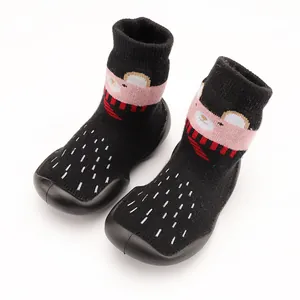 Detail view of cute cartoon animal pattern baby walking sock shoes with soft black soles
