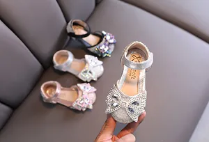 Detail view of sparkling rhinestone princess shoes for girls with elegant butterfly bow