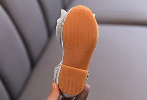Detail view of the durable non-slip gum rubber sole of the girls rhinestone princess shoe.